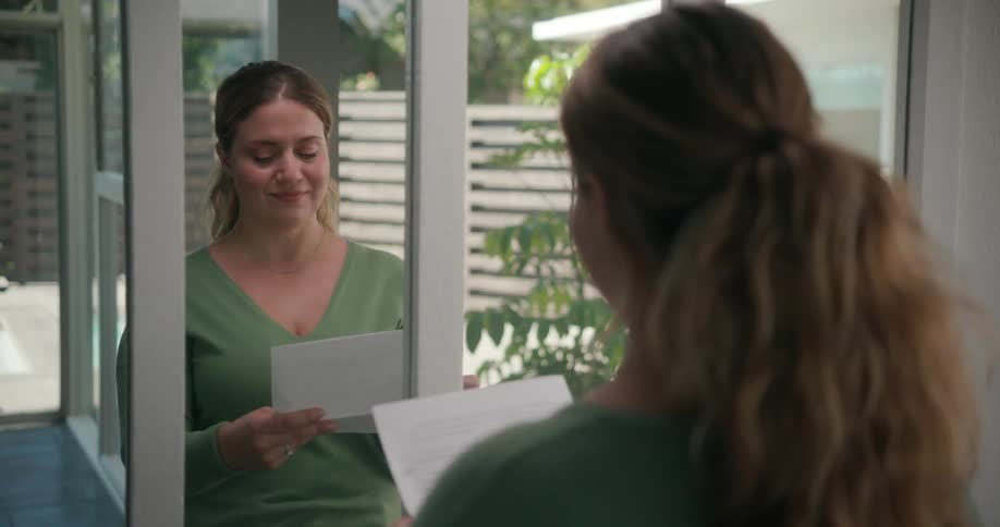 A woman practices speaking while looking into a mirror