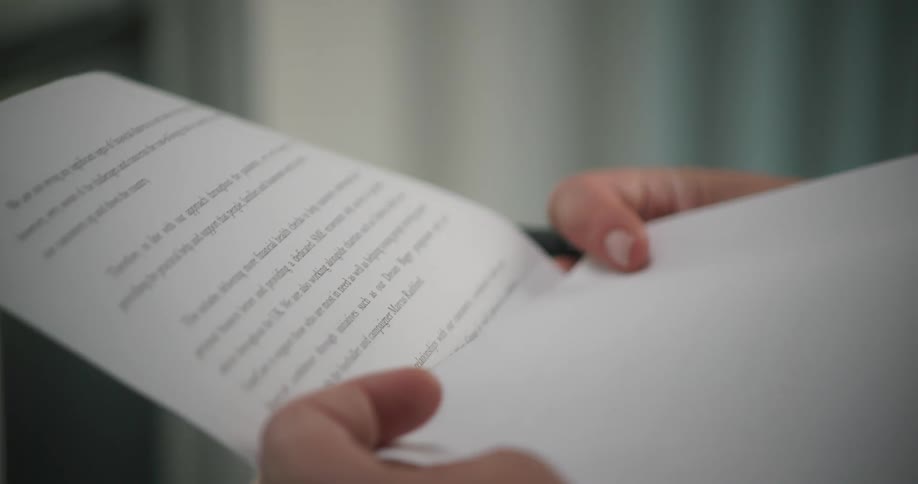 A woman flips through paperwork