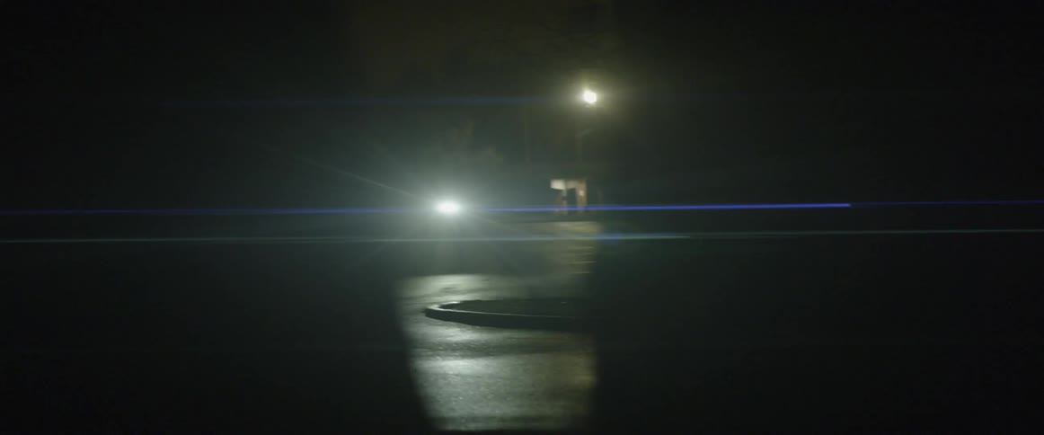 People with flashlights walking around in the dark