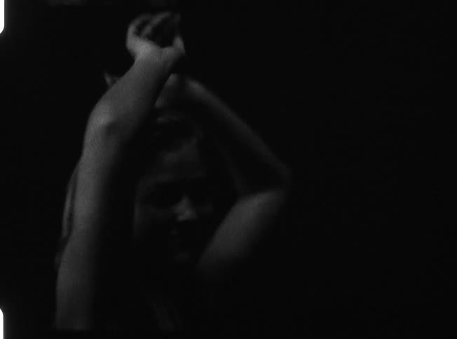 A woman dancing in the dark