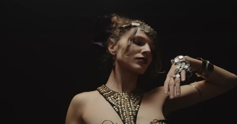 A woman belly dances in an elaborate costume