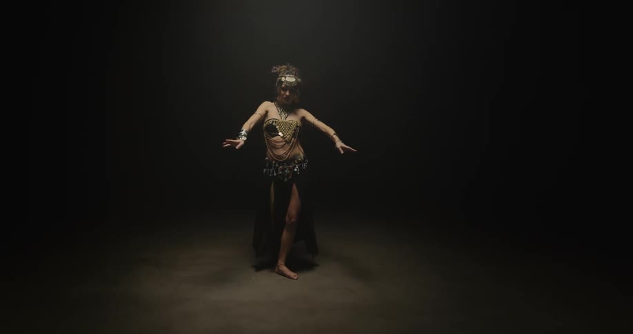 A woman is dancing by herself on a stage