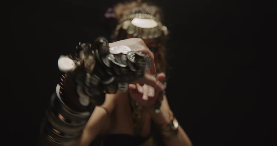 A dancer wearing a costume moving her arms a lot