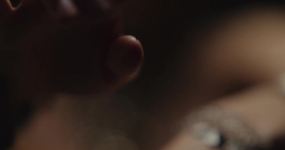 A dancer moving her jewelry covered hands up and down and extending her fingers