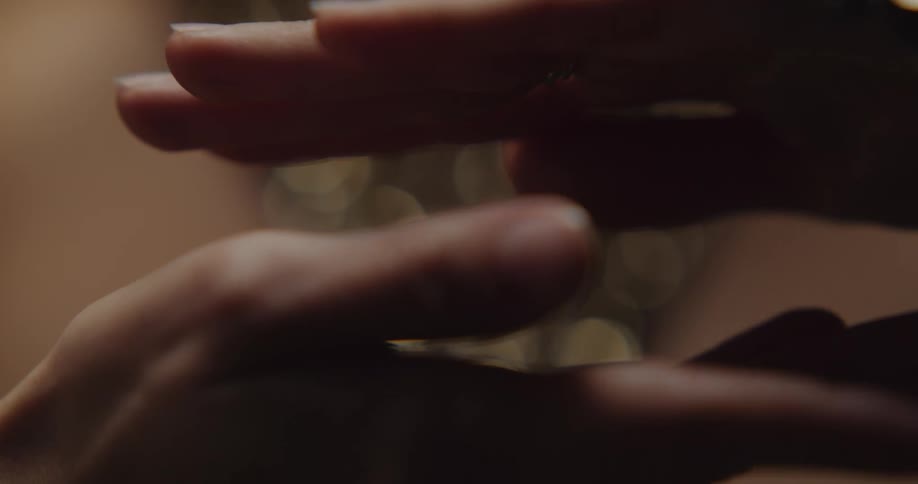 A belly dancer holds her hands close together