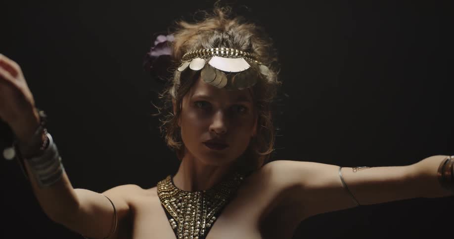A woman dancing in ornate jewelry