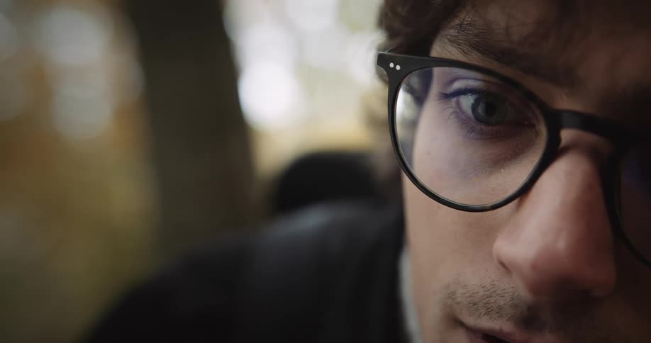 A close up of a man wearing black frame glasses