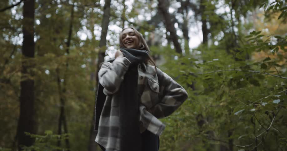 A young woman modeling clothes in the woods