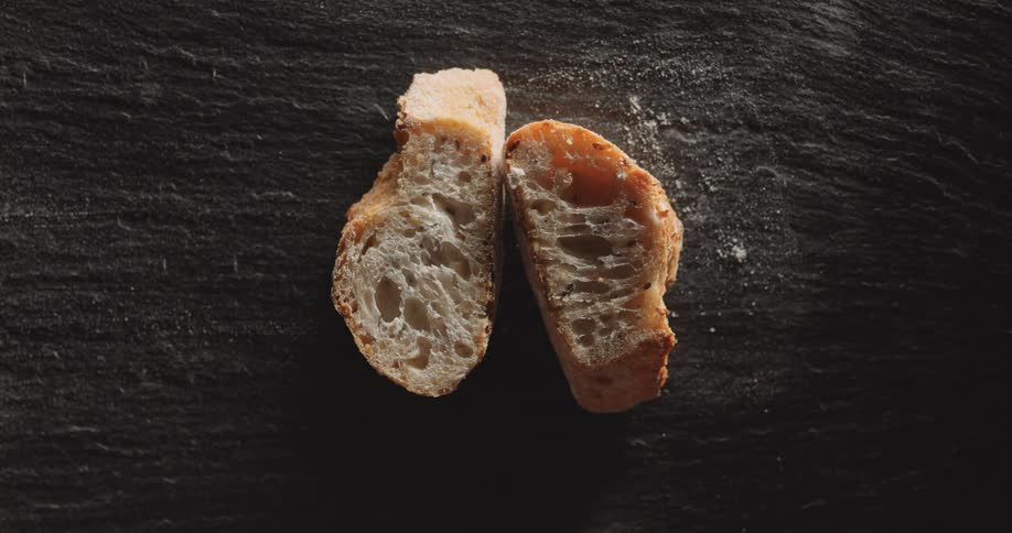 Two pieces of bread are placed on a table