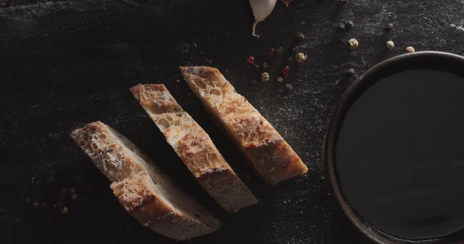 An overhead view of thickly sliced homemade bread on a tabletop in a kitchen