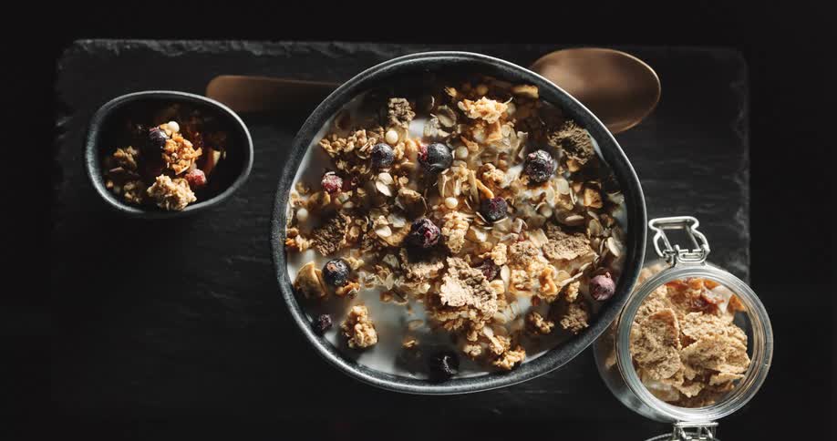 Granola cereal on a table in a few dishes