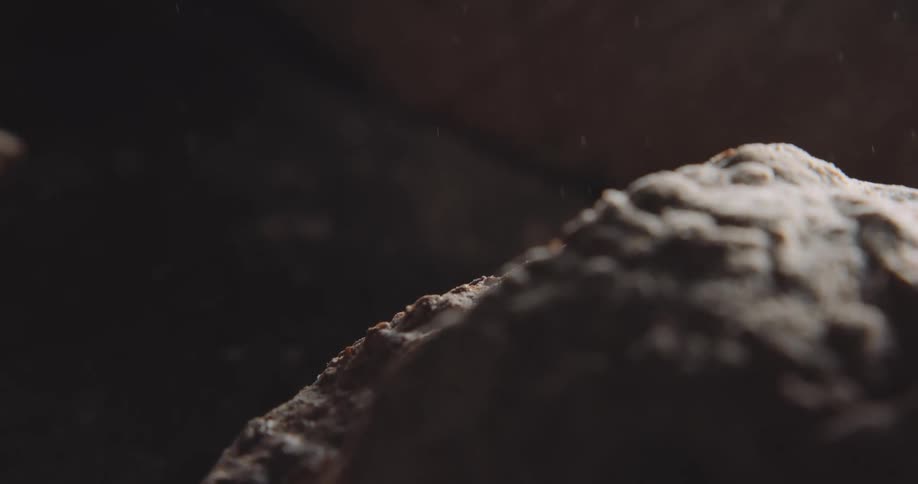Rain falls on a boulder in a canyon