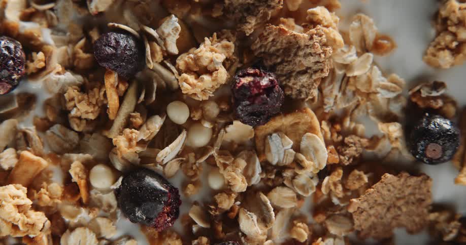 Fruit and nuts with granola and flakes in milk
