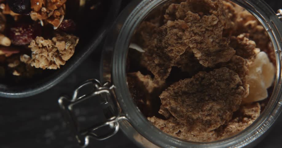 A close up of granola in a glass jar