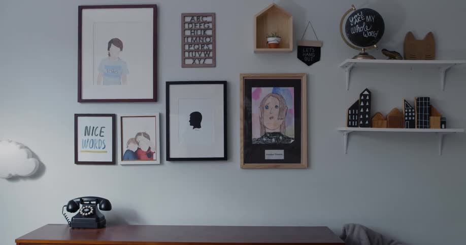 The view is of inside someones home and you can see the wall with paintings on it