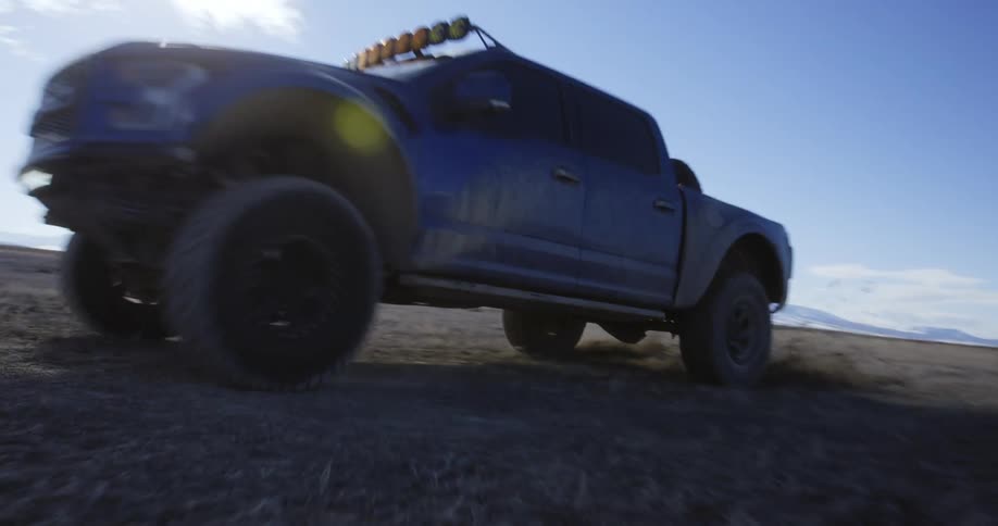 A truck races through the field