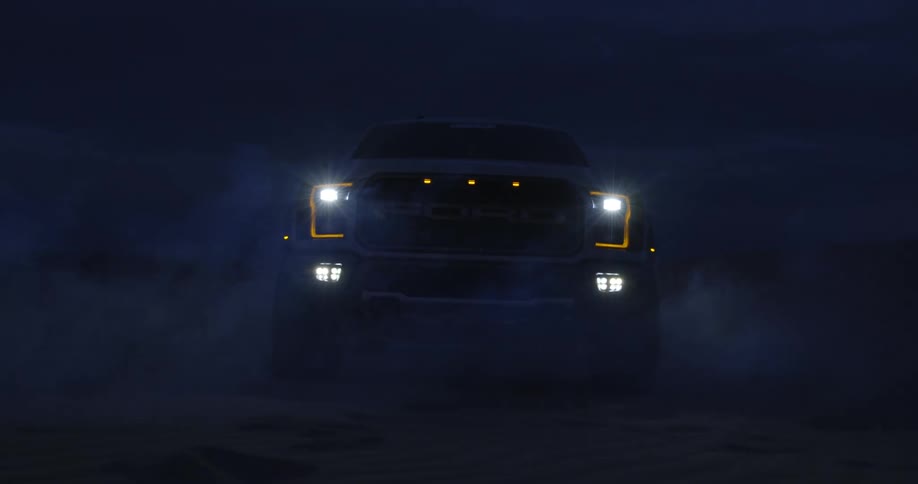 A truck is driving in the desert area at night time