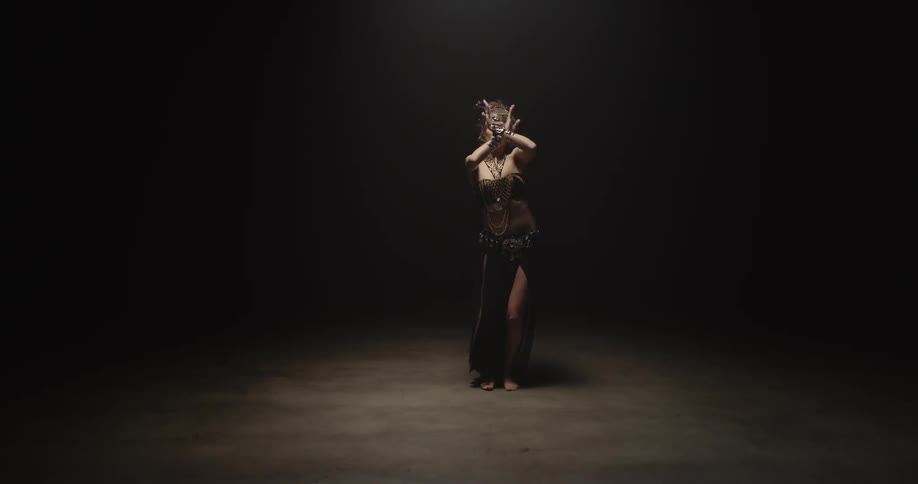 A woman is dancing in a room by herself