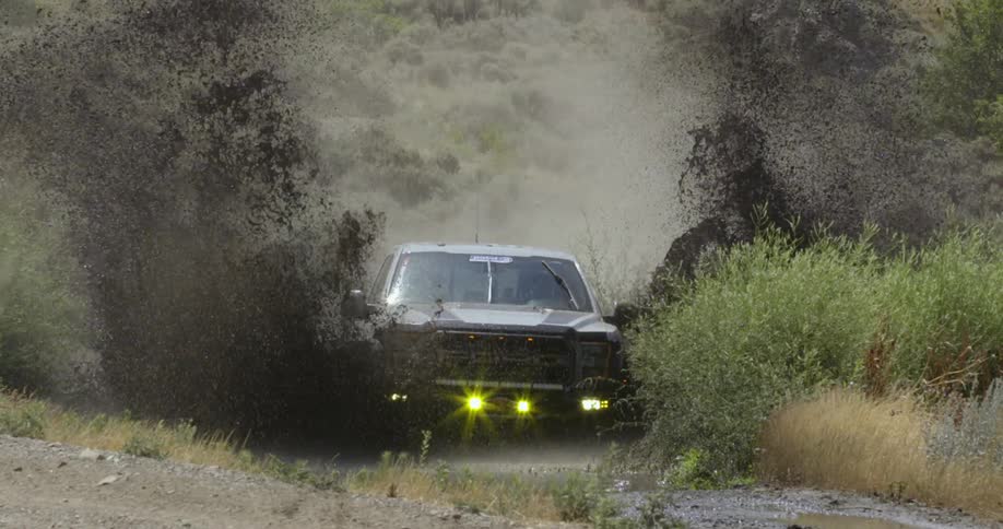 Slow motion view of a truck driving through water