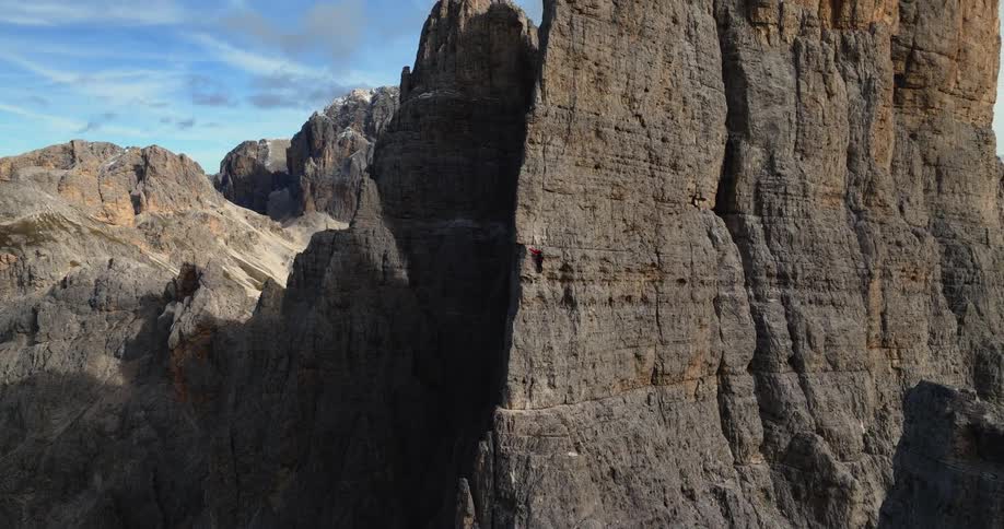 Aerial view of a person climbing the side of a mountain