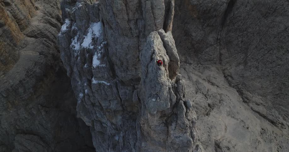 Aerial view of a person climbing up a mountain