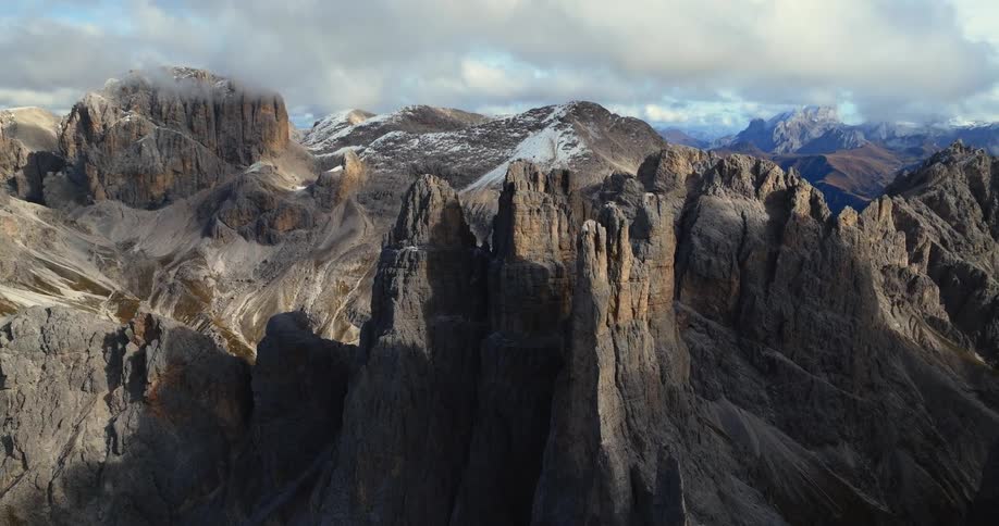 A dusting of snow settles on tall mountain peaks