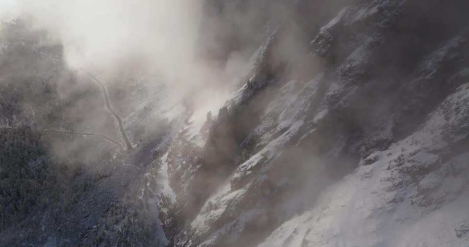 Birds eye view of snow covered mountains is displayed