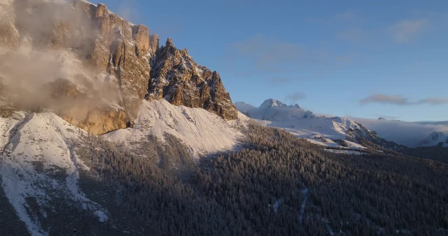 The view is of mountains in the outdoors around summer time