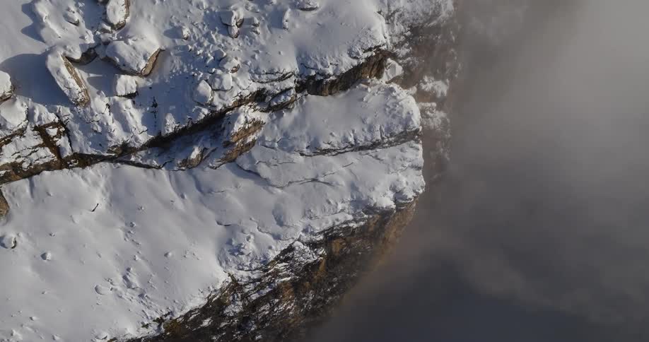 Birds eye view of snow covered mountains is displayed