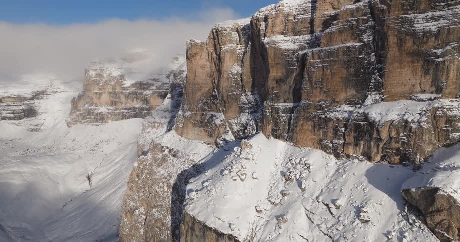 Aerial view of mountains covered in snow is displayed