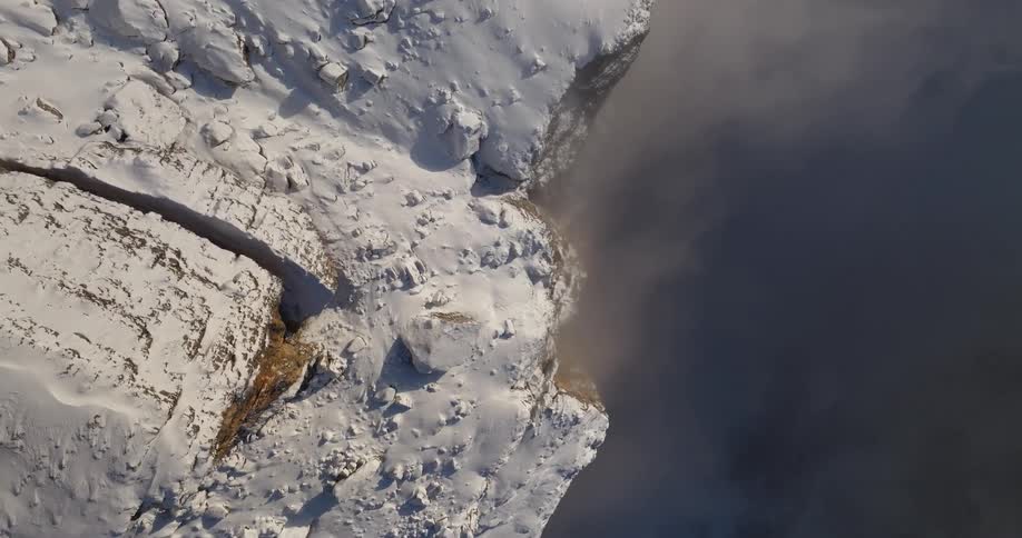 Slow motion view of snow covered mountains is displayed