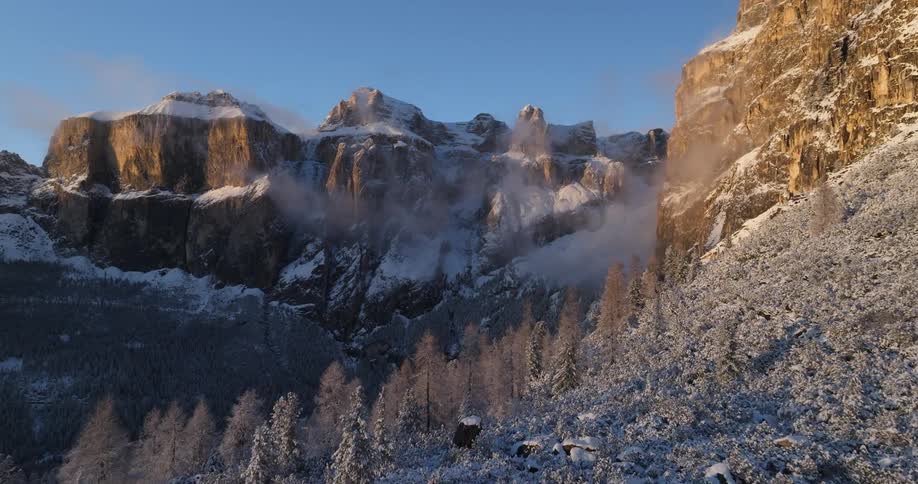 There are mountains that are covered with snow on them in the winter