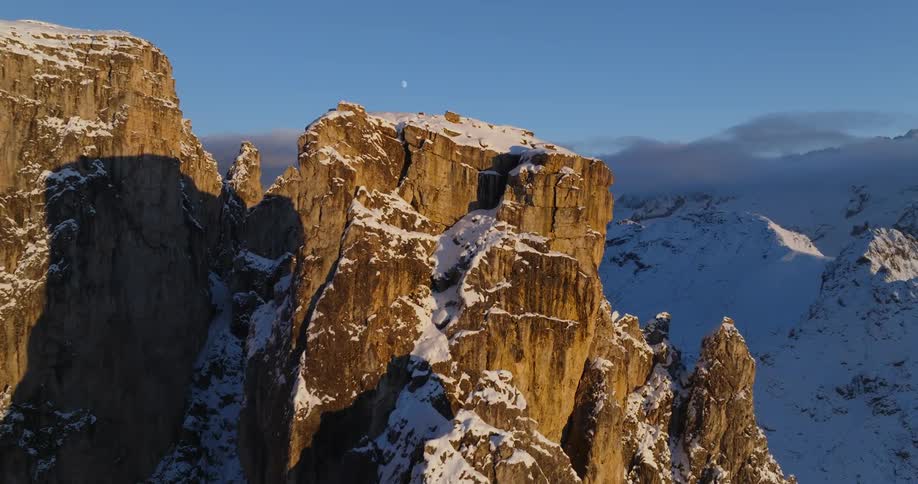 Aerial view of snowy steep mountain range peaks