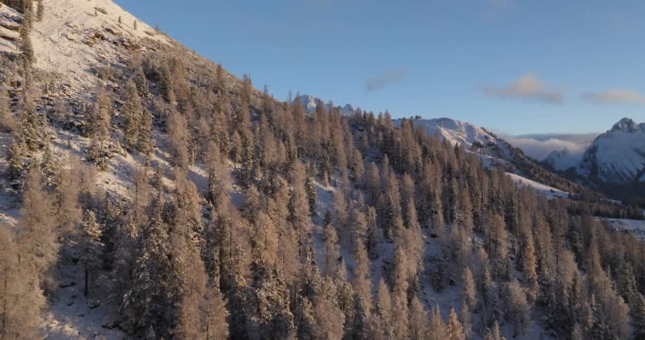 Aerial view of a mountain during winter is displayed at dusk