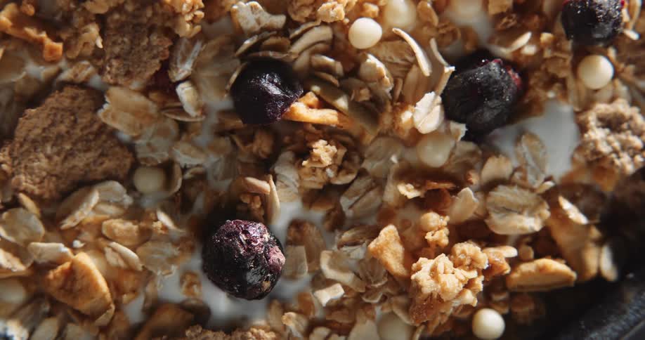 Extreme close up of raisins nuts and cranberries on a breakfast mix