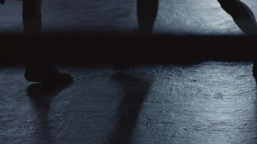 Silhouette shot of two brazilian teenagers sparring during a boxing training