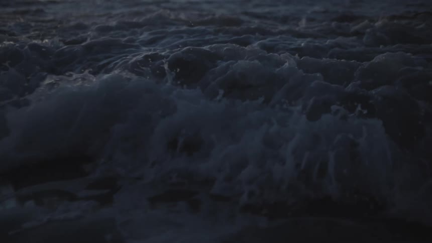 Light shines on the water as it ripples and waves roll into shore