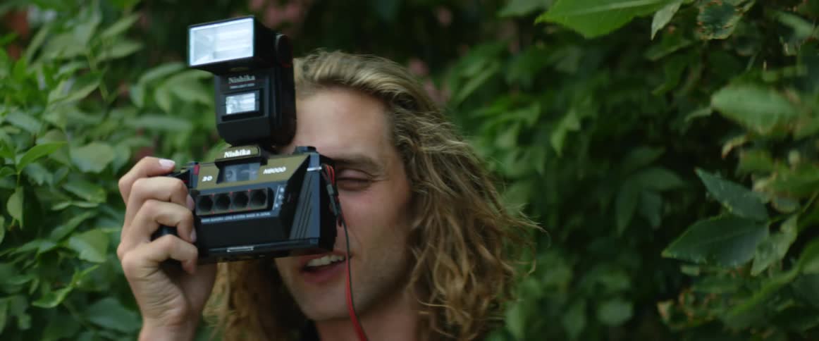 A male is taking photos outdoors in the spring time