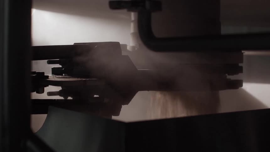 A machine is processing something into a vat