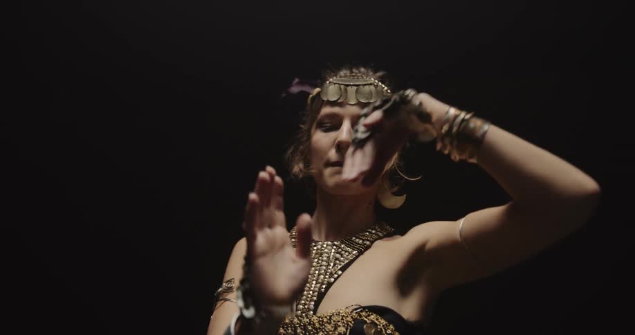 A young white woman is dancing and moving her hands