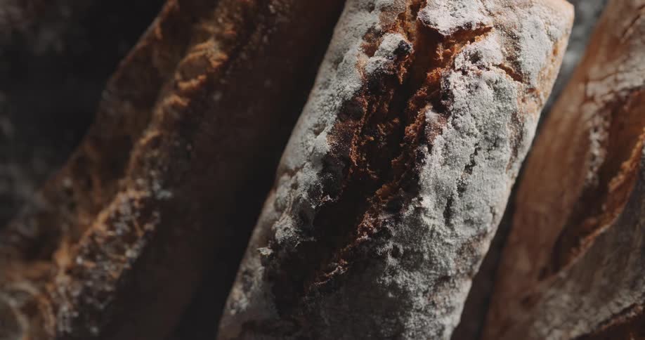 Light brightens to reveal details of crusty bread before fading again