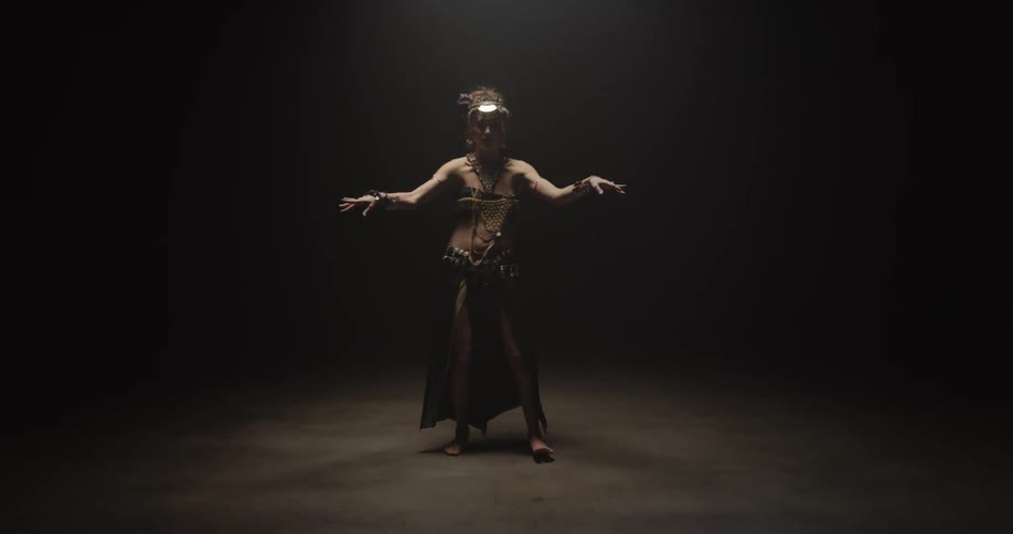 A woman is dancing by herself in a room