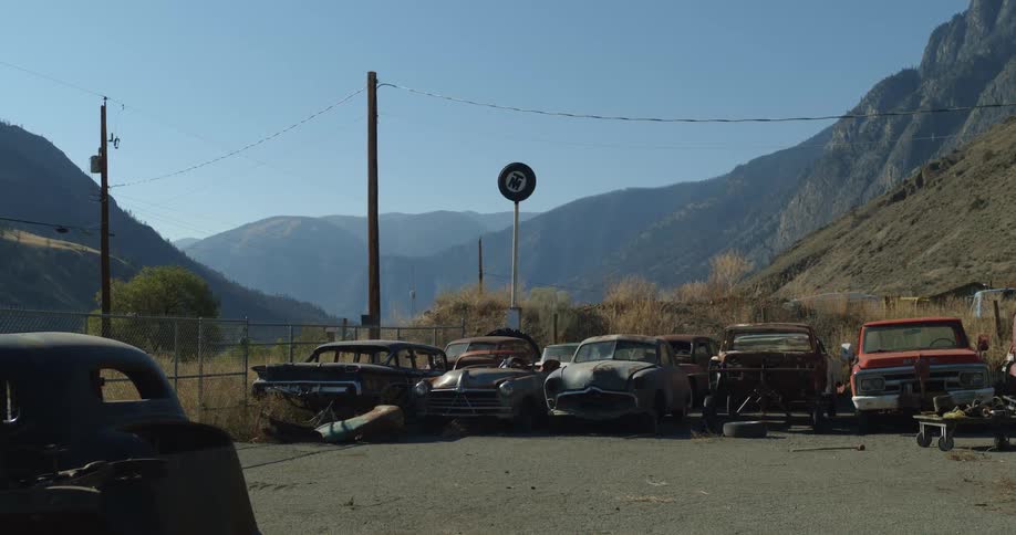 Old cars and parts of them collected in junkyard