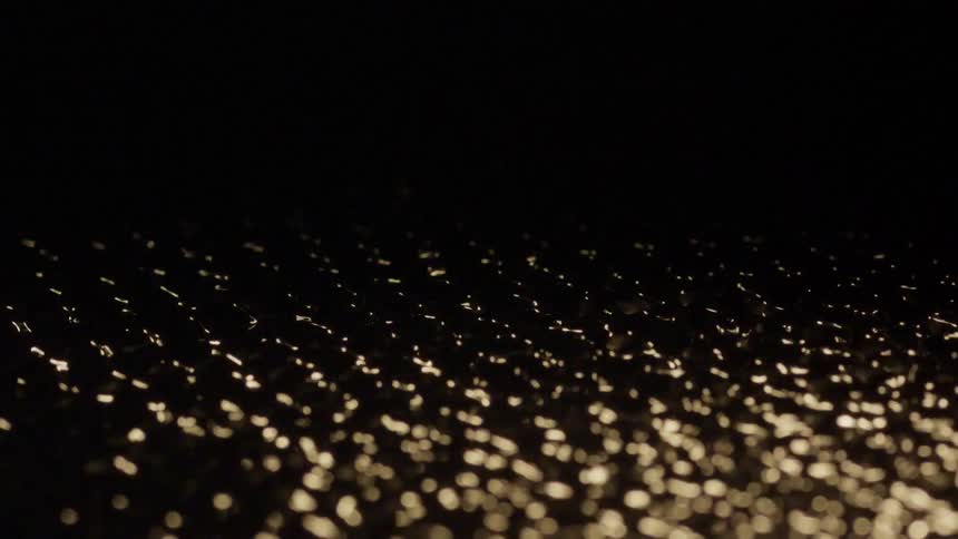An up close of water and droplets being vibrated and moving rapidly