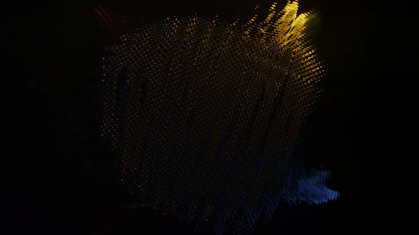 Dots of primary colors light on and off against a black background