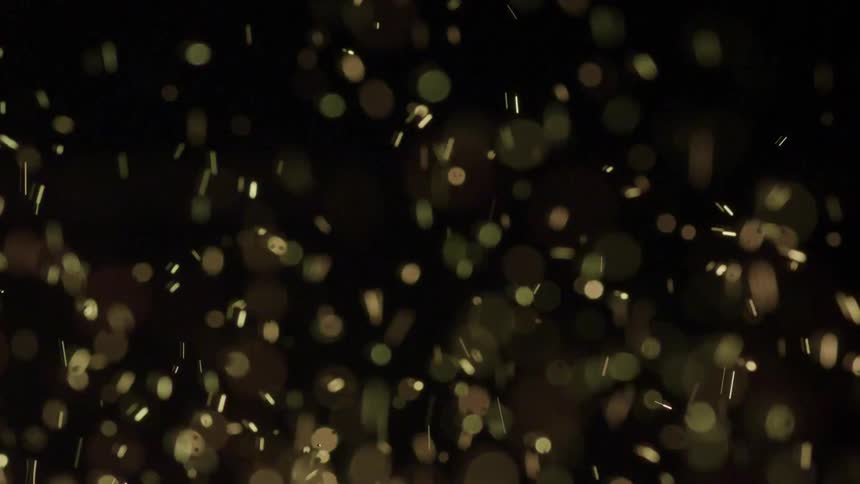 Particles are bouncing up and down in a studio setting with a solid black background