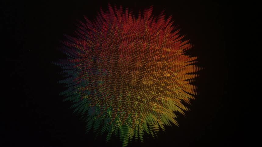 Rainbow colored ring with black center expands into starburst then sun