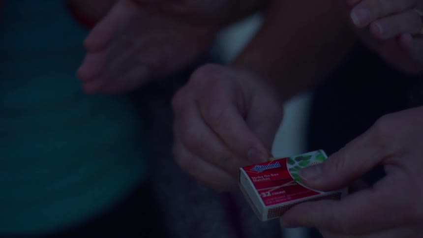 A person lights a match