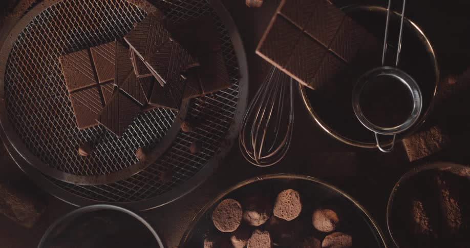 Chocolate bars cocoa and chocolate making equipment sit on flat surface