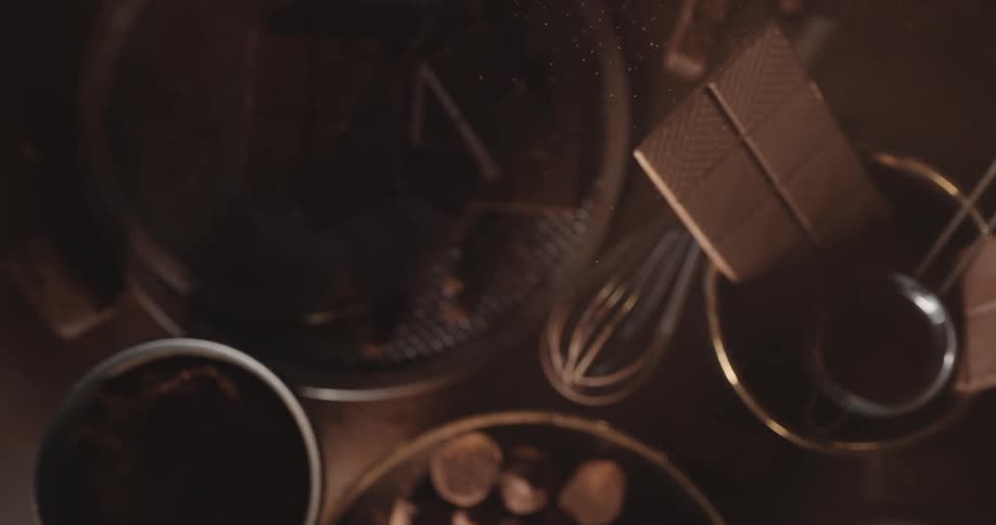 Ingredients and tools for making chocolate rest on a table